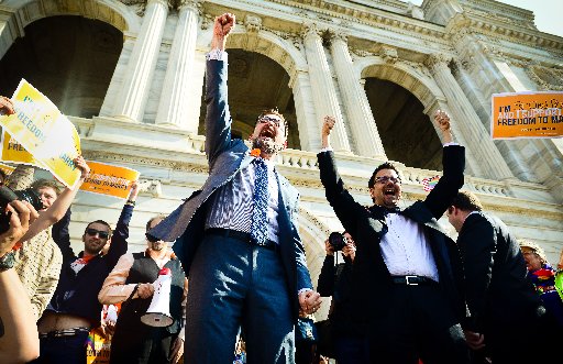 Sen. Scott Dibble, DFL-Minneapolis, left, sponsor of the gay marriage bill in the Minnesota Senate, and his partner Richard Leyva greet a large, joyous crowd as the arrive at the Minnesota State Capitol in St. Paul, Minn. on Monday, May 13, 2013. The...