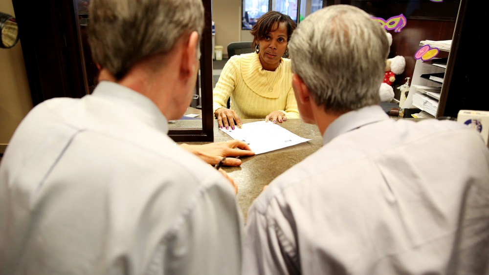 Robert Povilat, left, and Milton Persinger apply for their marriage license at Mobile County Probate Office after windows opened for the first time in four days in Mobile, Ala., on Feb. 12, 2015. (Photo by Sharon Steinmann/Mobile Press-Register/AP)