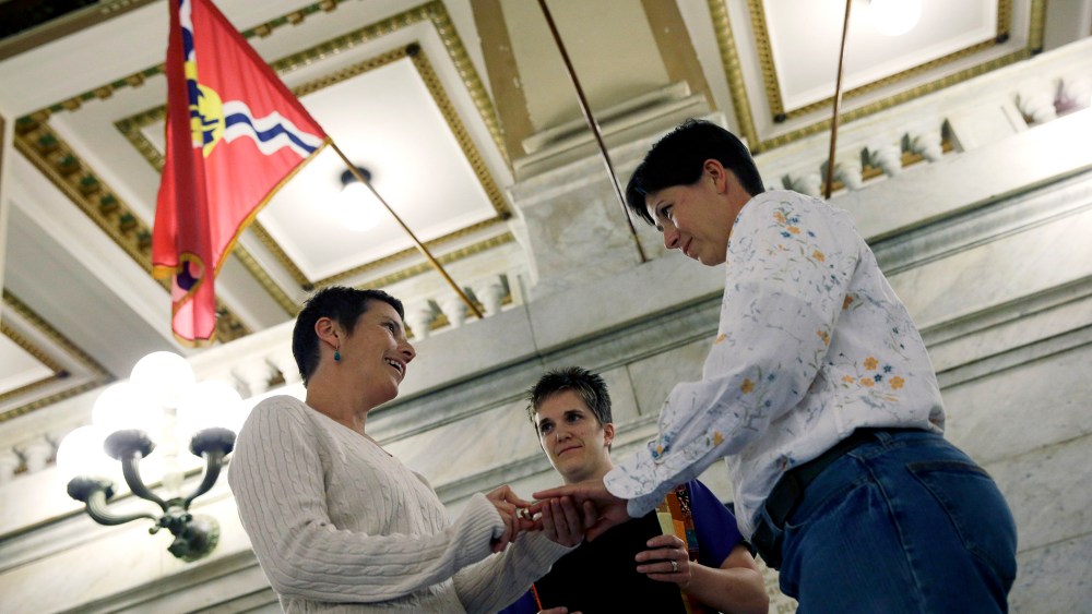 April Dawn Breeden, left, places a ring on the finger of her long-time partner Crystal Peairs, right, as they are married by Rev. Katie Hotze-Wilton on Nov. 5, 2014, at City Hall in St. Louis, Mo.