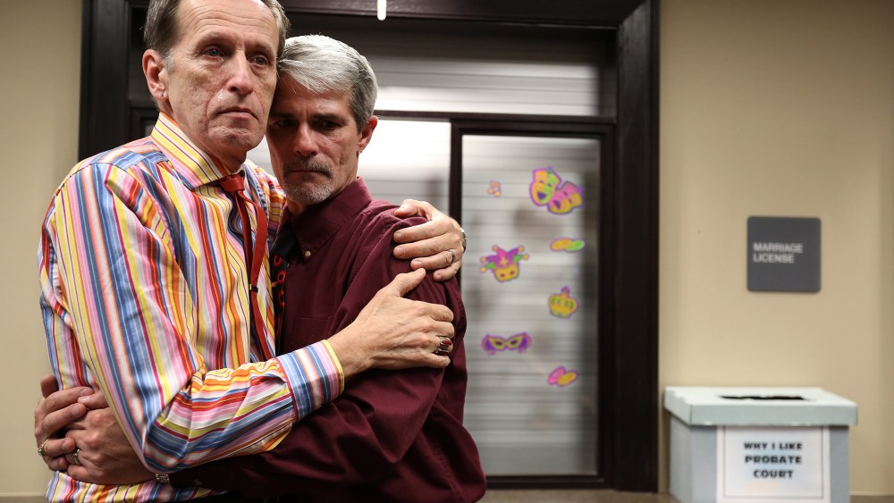 Robert Povilat, left, and Milton Persinger, comfort each other after hearing that for a second day, the Mobile County Probate office won't issue marriage licenses on Feb. 10, 2015 in Mobile, Ala.