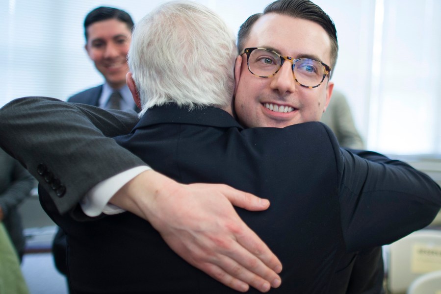 Thomas Rimbey Ogletree, center right, hugs his father, the Rev. Thomas Ogletree on March 10, 2014 in White Plains, N.Y.