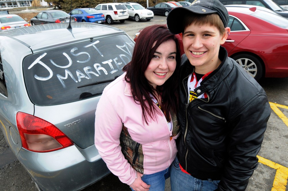 Megan D'Annunio, left, and Shannon D'Annunzio pose next to their car following their wedding ceremony, Saturday March 22, 2014, at the Oakland County Court complex in Pontiac, Michigan.