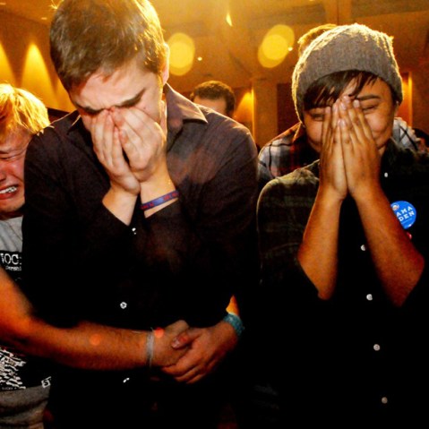 Anthony Streiff, Alex Sand and Nam Dorjee, all of Minneapolis, in tears upon learning voters rejected a proposed amendment to Minnesota's Constitution to ban gay marriage. (Jean Pieri/AP Photo)