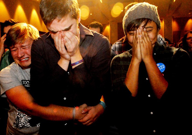 Anthony Streiff, Alex Sand and Nam Dorjee, all of Minneapolis, in tears upon learning voters rejected a proposed amendment to Minnesota's Constitution to ban gay marriage. (Jean Pieri/AP Photo)