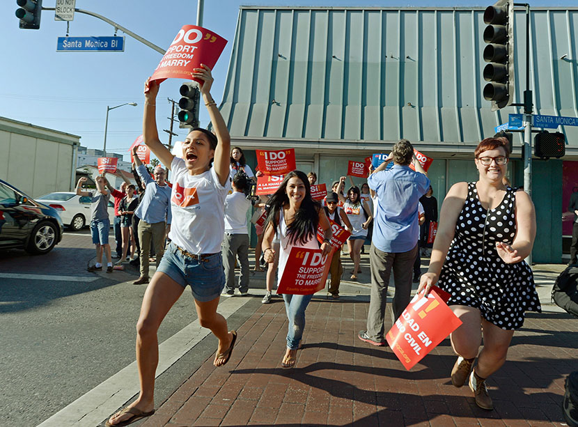 People celebrate in the street after the Supreme Court ruling at a watch party at Equality California, a non-profit civil rights organization that advocates for the rights of LGBT people in California, on June 26, 2013 in West Hollywood, California. ...