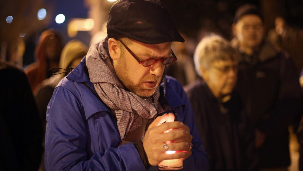 Michael Patter, senior minister at Central Congregational United Church of Christ, prays silently during a vigil for Kelly Gissendaner and protest against the death penalty on March 2, 2015, on the steps of the State Capitol.