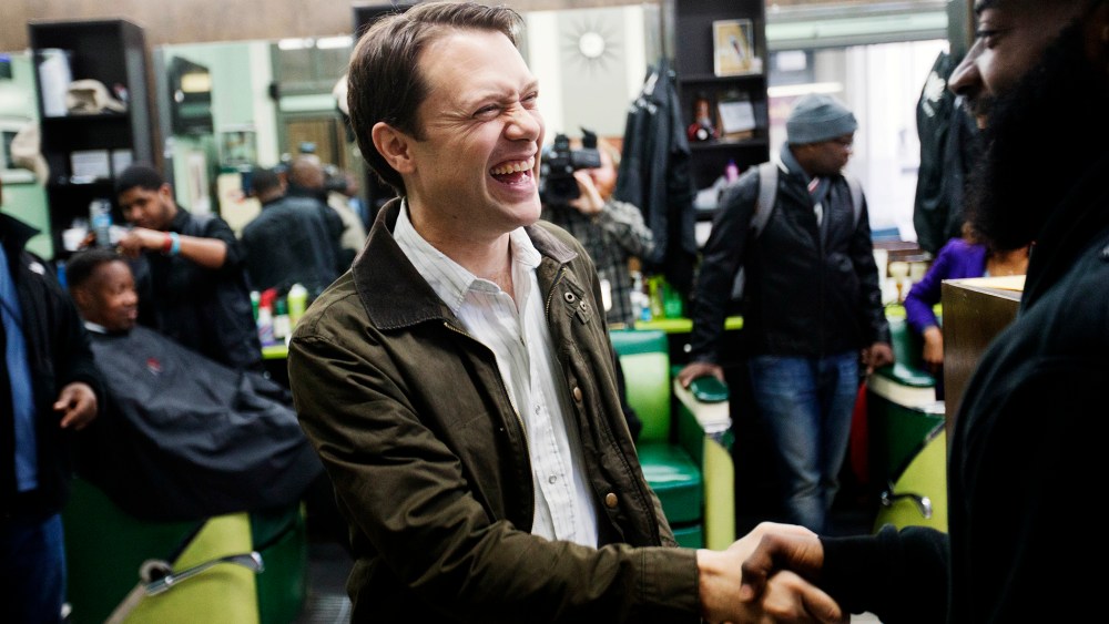 Georgia Democratic gubernatorial candidate Jason Carter, left, shakes hands with Herb Williams while greeting patrons at Vintage Barbershop in Atlanta, Ga. on Nov. 3, 2014.