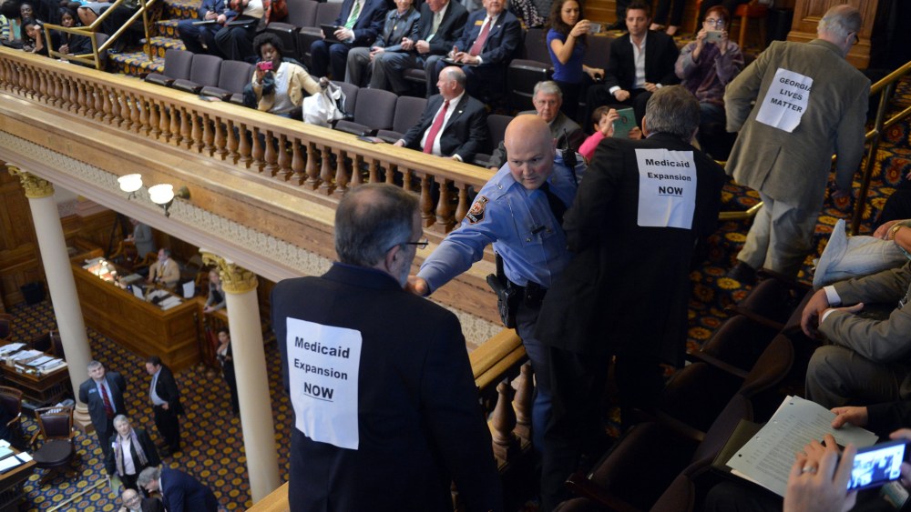 About 20 protestors are arrested at the Georgia state Capitol after disrupting the Senate, Tuesday, March 18, 2014.
