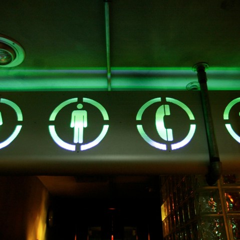 A sign points the way to the bathrooms, July 16, 2002. (Photo by Joe Raedle/Getty)