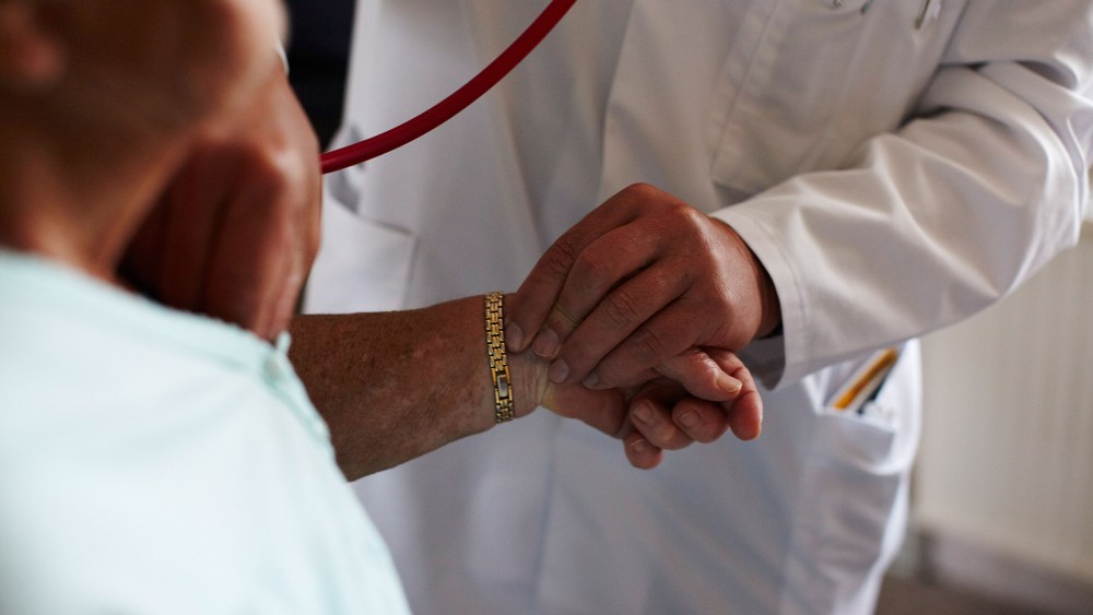 A doctor measures the blood pressure of a patient. (Photo by Carsten Koall/Getty)