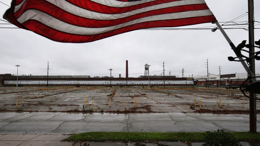 An overgrown parking lot lies empty in front of the closed Packard Electric complex on Oct. 29, 2012 in Warren, Ohio. (Photo by John Moore/Getty)