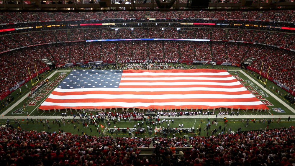 The United States flag covers the field during the national anthem before the Atlanta Falcons take on the San Francisco 49ers at the Georgia Dome on Jan. 20, 2013 in Atlanta, Ga. (Photo by Mike Ehrmann/Getty)