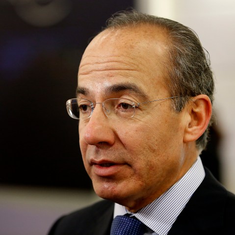 Felipe Calderon, former president of Mexico, speaks to an attendee in the halls on the opening day of the World Economic Forum (WEF) in Davos, Switzerland, Jan. 23, 2013. (Photo by Jason Alden/Bloomberg/Getty)