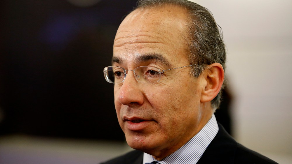 Felipe Calderon, former president of Mexico, speaks to an attendee in the halls on the opening day of the World Economic Forum (WEF) in Davos, Switzerland, Jan. 23, 2013. (Photo by Jason Alden/Bloomberg/Getty)