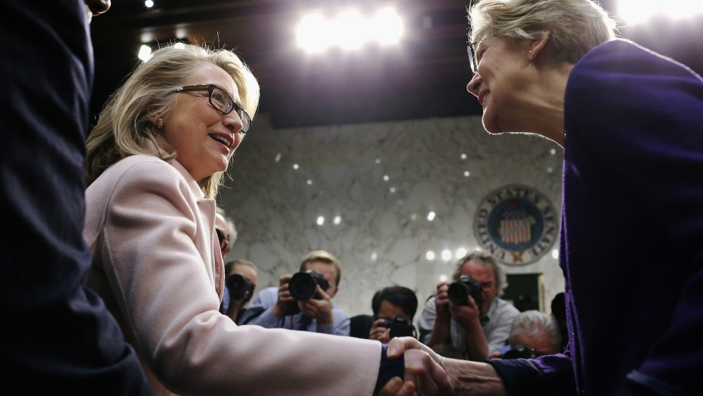 Hillary Clinton greets Sen. Elizabeth Warren as they arrive for Sen. John Kerry's confirmation hearing in the Hart Senate Office Building on Capitol Hill Jan. 24, 2013 in Washington, DC. (Photo by Chip Somodevilla/Getty)