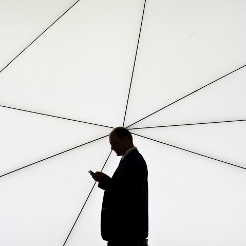A man checks his mobile phone on Feb. 25, 2013 in Barcelona, Spain. (Photo by David Ramos/Getty)