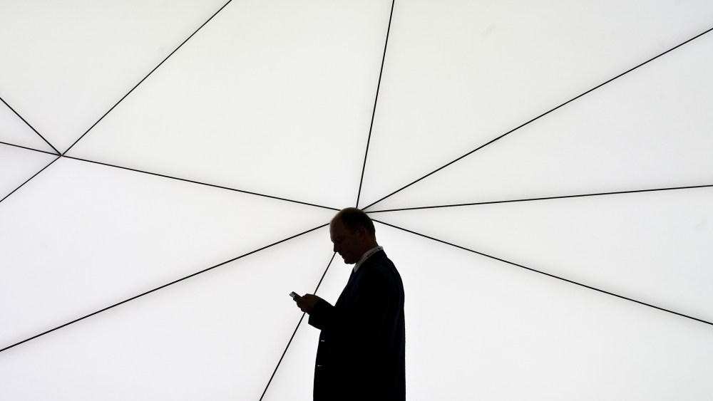 A man checks his mobile phone on Feb. 25, 2013 in Barcelona, Spain. (Photo by David Ramos/Getty)