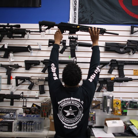A man puts a weapon on display (Photo by Joe Raedle/Getty).