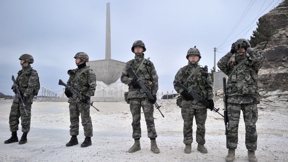 South Korean soldiers look at the sea as they patrol on the South-controlled island of Yeonpyeong near the disputed waters of the Yellow Sea at dawn on April 15, 2013. (Photo by Jung Yeon-Je/AFP/Getty)
