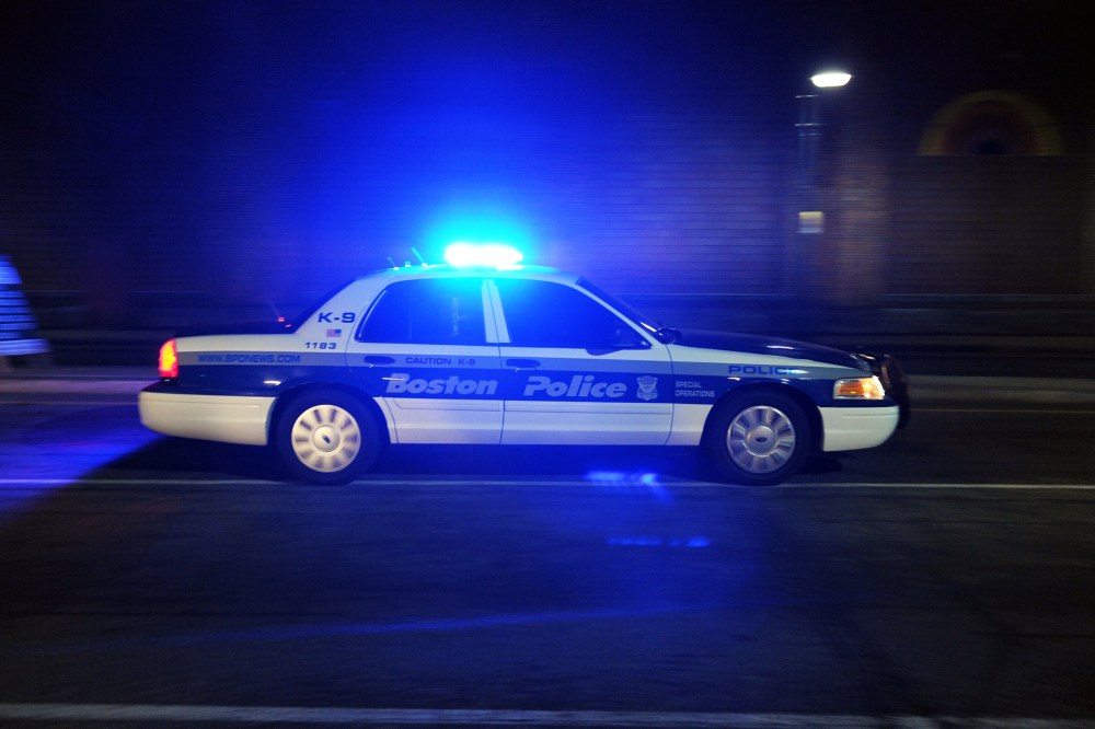 A Boston Police Department car drives down a street. (Photo by Stan Honda/AFP/Getty)