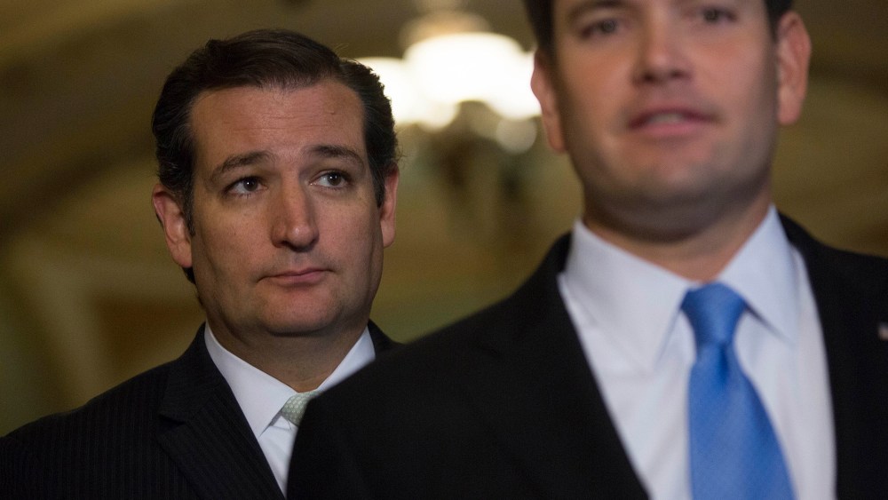Senator Ted Cruz looks on as Senator Marco Rubio speaks during a news conference with following a vote in Washington, D.C., Sept. 27, 2013. (Photo by Andrew Harrer/Bloomberg/Getty)