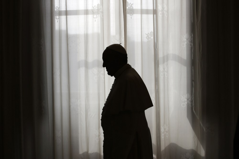 Pope Francis is silhouetted at the Vatican on Oct. 25, 2013. (Photo by Max Rossi/AFP/Getty)