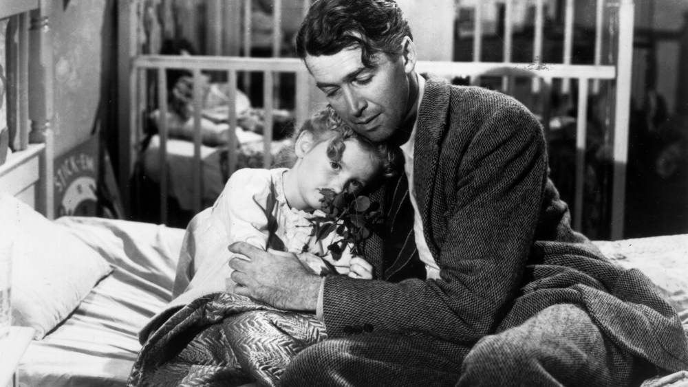 Actor James Stewart as George Bailey, hugs actor Karolyn Grimes, who plays Zuzu his daughter, in a still from director Frank Capra's Christmas classic film, 'It's a Wonderful Life'. (Photo by Hulton Archive/Getty)