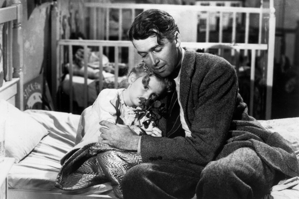 Actor James Stewart as George Bailey, hugs actor Karolyn Grimes, who plays Zuzu his daughter, in a still from director Frank Capra's Christmas classic film, 'It's a Wonderful Life'. (Photo by Hulton Archive/Getty)
