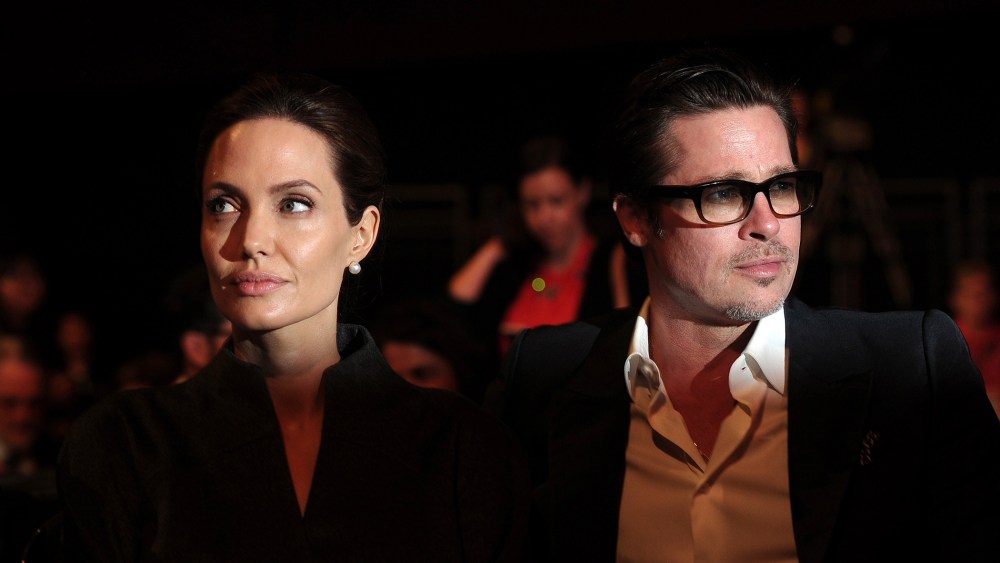Angelina Jolie (L) and her husband Brad Pitt attend the fourth day of the Global Summit to End Sexual Violence in Conflict in London on June 13, 2014. (Photo by Carl Court/AFP/Getty)
