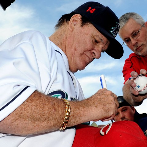 Former Major League Baseball player Pete Rose signs an autograph prior to managing the game for the Bridgeport Bluefish against the Lancaster Barnstormers on June 16, 2014 in Bridgeport, Conn. (Photo by Christopher Pasatieri/Getty)