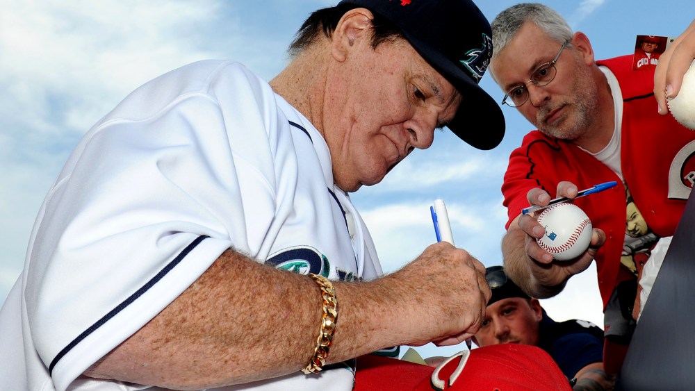 Former Major League Baseball player Pete Rose signs an autograph prior to managing the game for the Bridgeport Bluefish against the Lancaster Barnstormers on June 16, 2014 in Bridgeport, Conn. (Photo by Christopher Pasatieri/Getty)