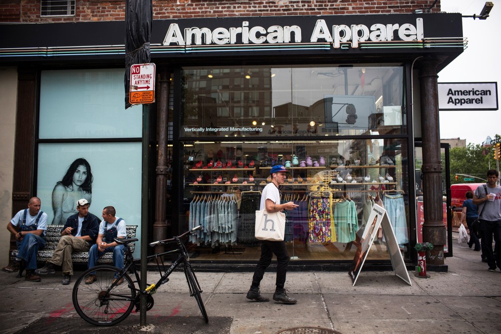 People walk past an American Apparel store on June 19, 2014 in New York, N.Y. (Photo by Andrew Burton/Getty)