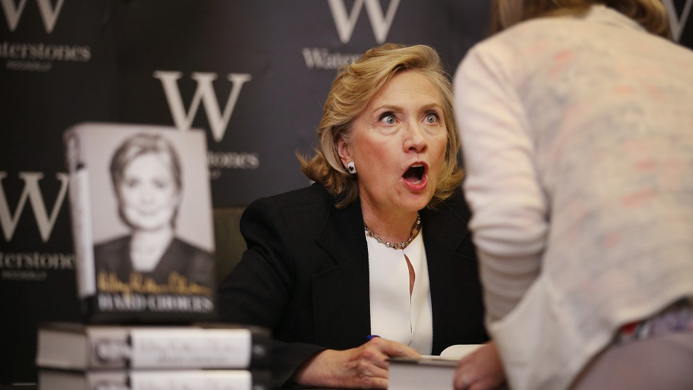 Former US Secretary of State Hillary Clinton reacts to a customer as she signs copies of her book at Waterstones bookshop on July 3, 2014 in London, England. (Photo by Peter Macdiarmid/Getty)