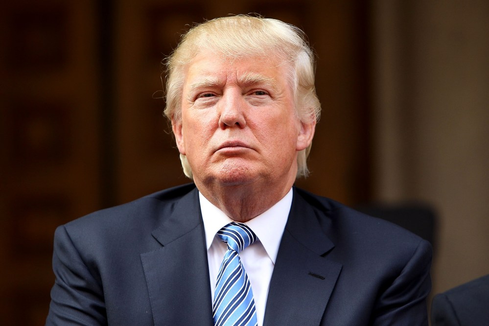 Donald Trump listens at the Trump International Hotel Washington, D.C, Groundbreaking Ceremony at Old Post Office on July 23, 2014. (Photo by Paul Morigi/WireImage/Getty)