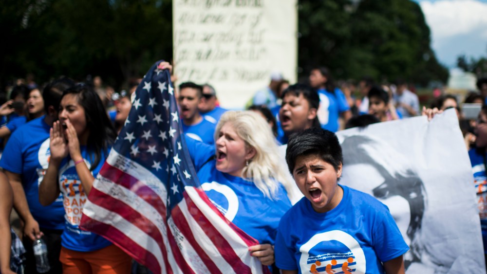 Immigration reform protesters with United We Dream chant in front of the White House to illustrate the stories of immigrant families on July 28, 2014. (Photo by Bill Clark/CQ Roll Call/Getty)