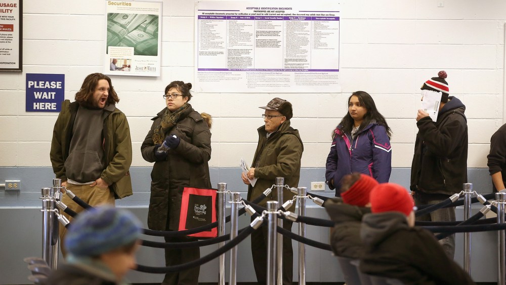 Illinois residents wait in line to apply for or renew their driver's license at a driver services facility on Dec. 10, 2013. (Photo by Scott Olson/Getty)