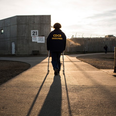 George Whitfield, age 56 and in prison for marijuana-related charges, uses a walker to walk back to his cell block at California State Prison, Solano, on December 16, 2013 in Vacaville, California. (Photo by Andrew Burton/Getty)