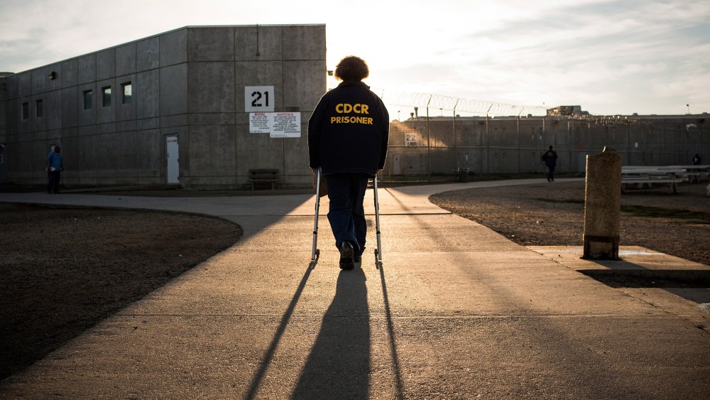George Whitfield, age 56 and in prison for marijuana-related charges, uses a walker to walk back to his cell block at California State Prison, Solano, on December 16, 2013 in Vacaville, California. (Photo by Andrew Burton/Getty)
