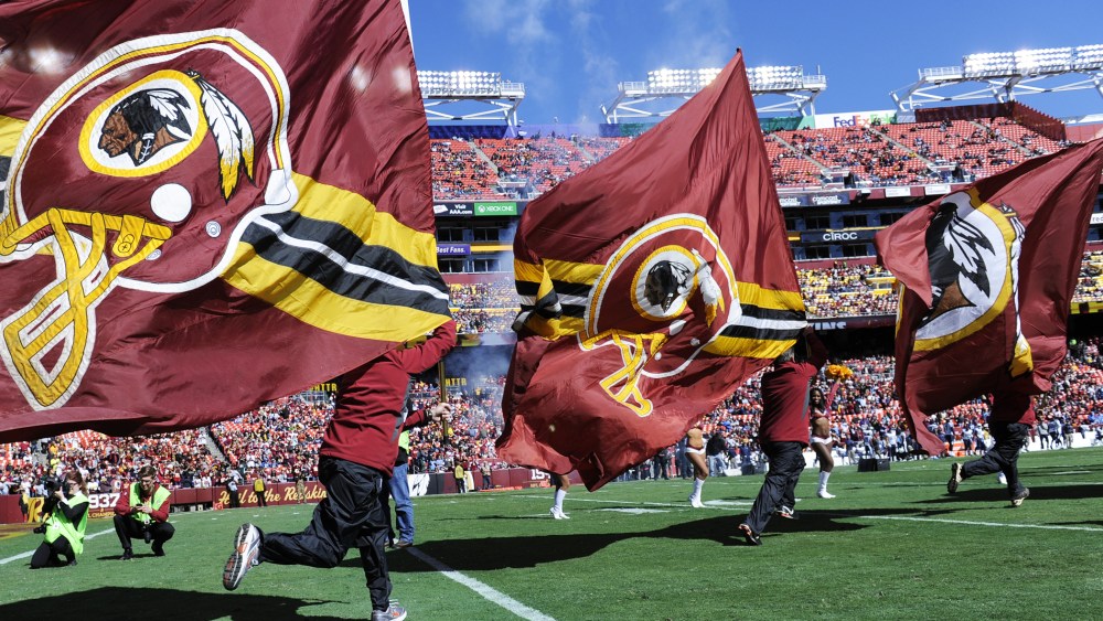 The flag crew runs onto the field before the game between the Washington Redskins and the Tennessee Titans at FedEx Field on Oct. 19, 2014. (Photo by Toni L. Sandys/The Washington Post/Getty)
