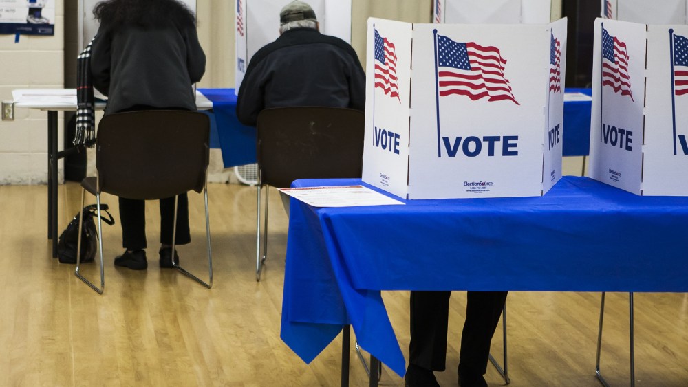Voters fill out their ballots at a polling station during US mid-term elections in McLean, Va. (Photo by Samuel Corum/Anadolu Agency/Getty).
