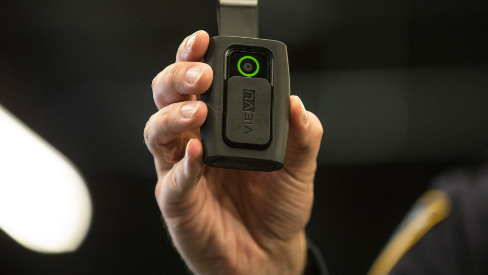 NYPD Sergeant Joseph Freer demonstrates how to use and operate a body camera during a media press conference on Dec. 3, 2014 in New York City. (Photo by Andrew Burton/Getty)