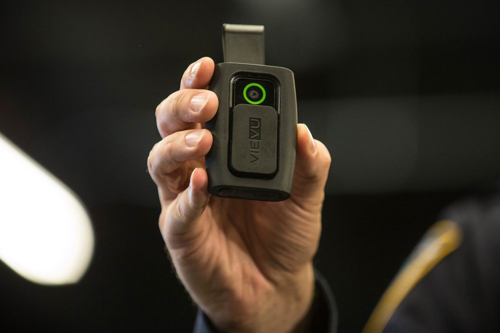 NYPD Sergeant Joseph Freer demonstrates how to use and operate a body camera during a media press conference on Dec. 3, 2014 in New York City. (Photo by Andrew Burton/Getty)