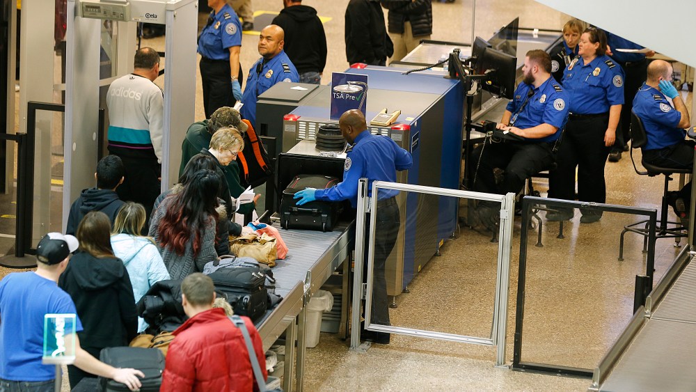 Passengers make their way through a Transportation Security Administration (TSA) check point at Salt Lake City International Airport in Salt Lake City, Utah, Dec. 23, 2014. (Photo by George Frey/Bloomberg/Getty)