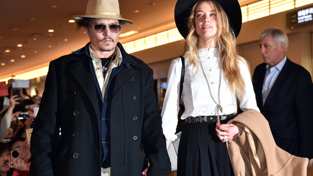 Actor Johnny Depp (L), accompanied by his fiancee US actress and model Amber Heard (R), arrive at Tokyo International Airport on Jan. 26, 2015. (Photo by Yoshikazu Tsuno/AFP/Getty)