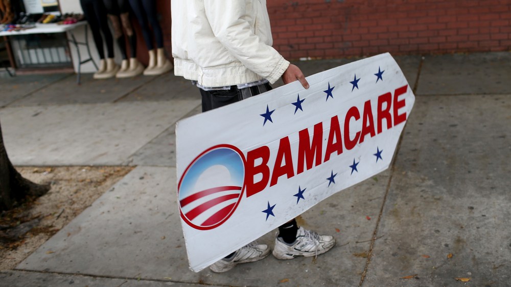Pedro Rojas holds a sign directing people to an insurance company where they can sign up for the Affordable Care Act, also known as Obamacare, before the February 15th deadline on Feb. 5, 2015 in Miami, Fla.  (Joe Raedle/Getty)