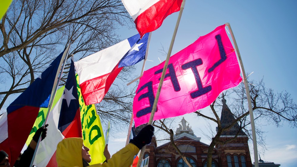 A group from Texas display their flags during a rally on the Mall for the March for Life anti-abortion demonstration. (Photo By Tom Williams/CQ Roll Call/Getty)
