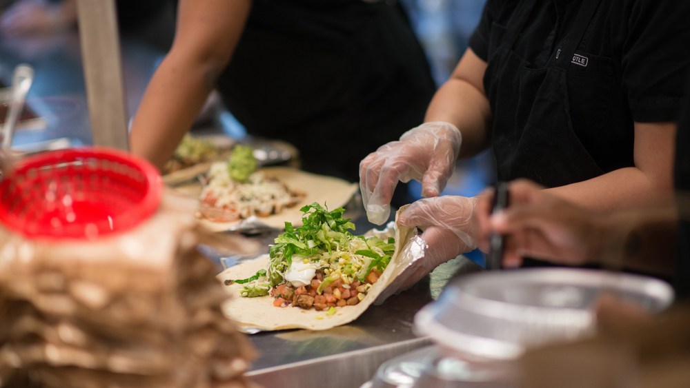 Employees prepare lunch orders at a Chipotle Mexican Grill restaurant. (Photo by Craig Warga/Bloomberg/Getty)