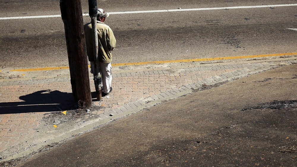 A homeless man looks for donations along a highway entrance on March 28, 2015 in Corpus Christi, Texas. (Photo by Spencer Platt/Getty)
