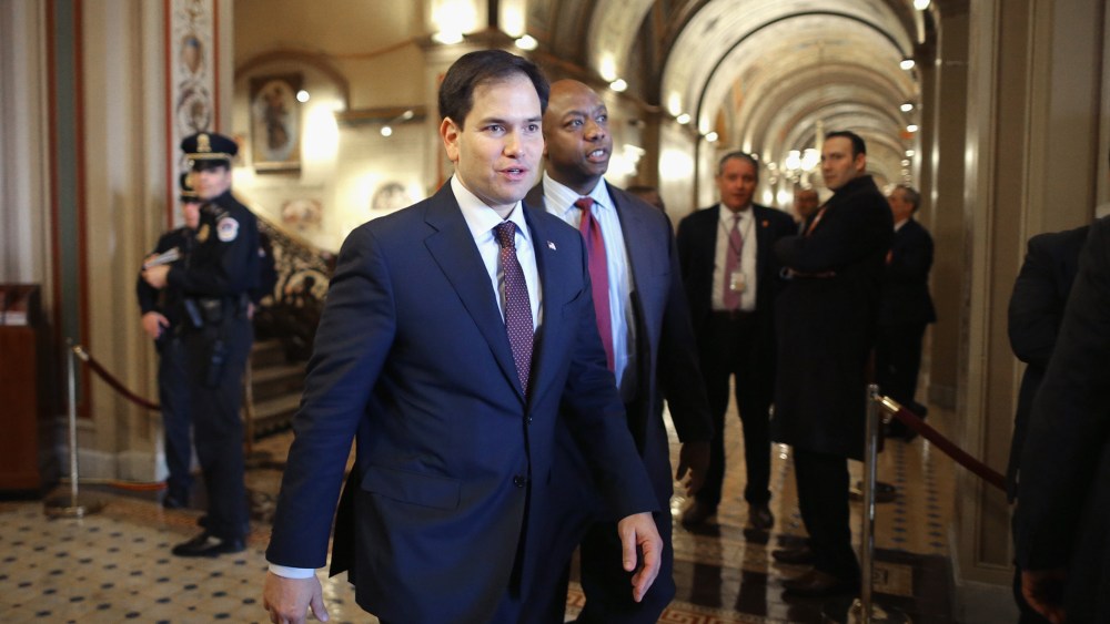 U.S. Sen. Marco Rubio and Sen. Tim Scott walk through the U.S. Capitol on Feb. 12, 2014 in Washington, DC. (Photo by Chip Somodevilla/Getty)