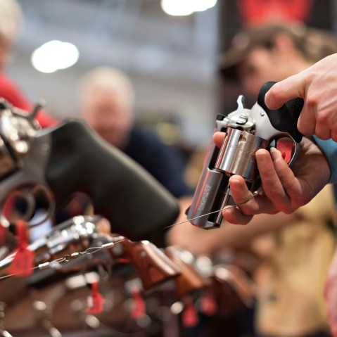 An attendee handles a revolver in the Sturm, Ruger & Co., Inc. booth on the exhibition floor of the 144th National Rifle Association (NRA) Annual Meetings and Exhibits in Nashville, Tenn. on April 11, 2015. (Photo by Daniel Acker/Bloomberg/Getty)